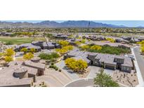 Expansive aerial shot highlighting the home's desert landscape, paver driveway, golf course, and surrounding community at 12325 S 179Th S Ave # 0, Goodyear, AZ 85338