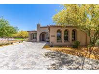 Charming home with desert landscaping, paver driveway, arched windows, and a well-maintained exterior at 12325 S 179Th S Ave # 0, Goodyear, AZ 85338