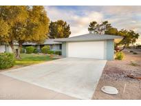 Attractive single-story home boasts a large driveway, attached two-car garage, and manicured front yard at 12739 W Prospect Dr, Sun City West, AZ 85375