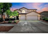 Charming two-story home with a three car garage and landscaped front yard at 13965 N 135Th Dr, Surprise, AZ 85379