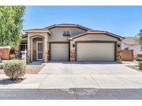 Inviting single-story home with a two-car garage and low-maintenance landscaping at 17429 W Red Bird Rd, Surprise, AZ 85387