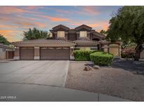Beautiful two-story home features a three-car garage and a well-manicured front yard with mature landscaping at 30 W Sheffield Ave, Gilbert, AZ 85233