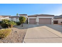 Charming single-story home features a spacious driveway, three-car garage, and desert landscaping at 3085 E Parkview Dr, Gilbert, AZ 85295