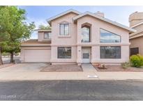 Two-story home featuring a two car garage, well-manicured lawn, and covered entrance at 4201 W Renee Dr, Glendale, AZ 85308