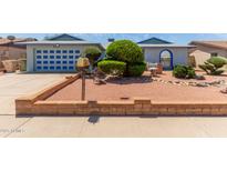 Charming single-Gathering home featuring a well-maintained front yard with beautiful landscaping and brick accents at 5215 W Onyx Ave, Glendale, AZ 85302