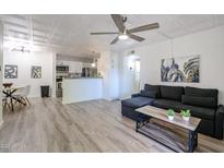 Bright living room featuring an open floor plan and a stylish ceiling fan at 8055 E Thomas Rd # 104, Scottsdale, AZ 85251
