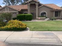 Charming single-story home featuring a well-maintained lawn and desert landscaping at 9733 W Mcrae Way, Peoria, AZ 85382