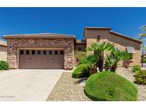 Charming single-story home with a two-car garage, desert landscaping, and a well-maintained yard at 13052 W Mine Trl, Peoria, AZ 85383