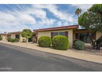 Charming single-story home featuring desert landscaping, a gated entryway, and lovely curb appeal at 13618 N 98Th Ave # C, Sun City, AZ 85351