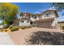 Inviting two-story home boasting a brick driveway, spacious two-car garage, and elegant architectural details at 14674 W Pasadena Ave, Litchfield Park, AZ 85340
