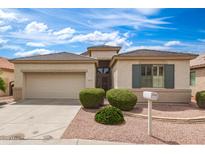 Charming single-story home features low-maintenance landscaping, tile roof, and two car garage at 18131 W Addie Ln, Surprise, AZ 85374