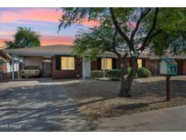 Charming single-story brick home featuring a covered parking area and a beautifully xeriscaped front yard at 2015 W Weldon Ave, Phoenix, AZ 85015