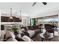 Inviting living room with a comfortable leather sofa and seamless indoor-outdoor flow to a private pool area at 2114 N Canelo Hls, Mesa, AZ 85207
