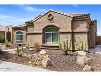 Charming single-story home featuring desert landscaping and a well-maintained stucco facade at 21200 E Camacho Rd, Queen Creek, AZ 85142