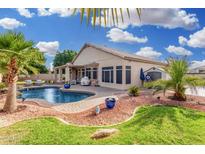 Serene backyard showcasing a private pool with a lush lawn and patio, perfect for outdoor entertaining at 22351 N 67Th Dr, Glendale, AZ 85310
