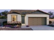 Charming single-story home featuring a 2-car garage, stone accents, and well-maintained landscaping at 25139 W Wayland Dr, Buckeye, AZ 85326