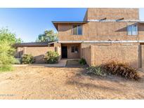 Exterior view of a two-story townhome featuring desert landscaping and a private front patio at 6902 W Devonshire Ave # 1280, Phoenix, AZ 85033