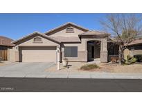 Single story home featuring a two car garage and desert landscaping at 8014 W Beaubien Dr, Peoria, AZ 85382