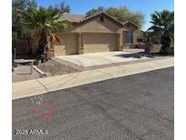 Tan home features a three-car garage, mature landscaping, and desert-style curb appeal at 840 W Crooked Stick Dr, Casa Grande, AZ 85122