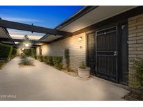 Inviting exterior view with covered walkway and landscaped details leading to the front door at 110 W Missouri Ave # 18, Phoenix, AZ 85013