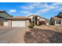 Charming one-story home with a two-car garage and low-maintenance desert landscaping at 11805 N 90Th Way, Scottsdale, AZ 85260