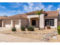 Inviting single-story home with a tile roof and low-maintenance desert landscaping at 14470 N 98Th Pl, Scottsdale, AZ 85260