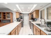 Bright and modern kitchen featuring stainless steel appliances, white countertops and tile floors at 18522 N Mica Dr, Sun City West, AZ 85375