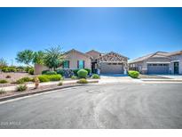 Charming single-story home featuring stone accents, a two-car garage, and meticulously maintained landscaping at 21551 E Waverly Ct, Queen Creek, AZ 85142