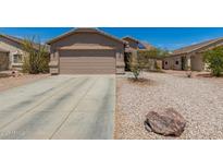 Charming single-Gathering home displaying a two-car garage and desert landscaping at 22544 W Mohave St, Buckeye, AZ 85326