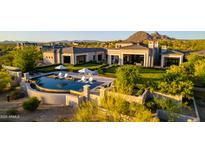 An aerial view of a luxury home with a pristine pool and desert landscaping in an upscale community at 24066 N 90Th Way, Scottsdale, AZ 85255