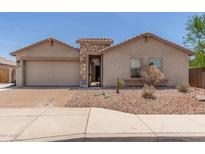 Charming single-story home with a brick-paved driveway and beautiful desert landscaping at 25667 W Primrose Ln, Buckeye, AZ 85326