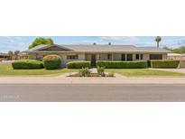 Charming single story home featuring well-maintained landscaping and mature shrubbery at 400 N Jay N St, Chandler, AZ 85225