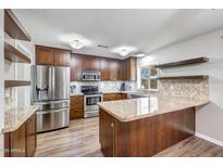 Beautiful kitchen with granite countertops, stainless steel appliances, and wooden cabinets at 4808 W Shaw Butte Dr, Glendale, AZ 85304