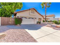 Charming single Gathering home with desert landscaping and a two car garage at 6122 E Saddleback St, Mesa, AZ 85215