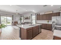 Spacious open-concept layout featuring kitchen, living, and dining areas at 681 W Belmont Red Trl, San Tan Valley, AZ 85143