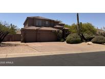 Charming two-story home with a well-manicured front yard and desert landscaping at 6939 E Upper Trail Cir # 16, Mesa, AZ 85207