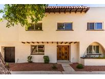 Charming two-story home with unique architectural details and a well-maintained front yard at 7665 E Montecito Ave, Scottsdale, AZ 85251