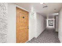 Hallway leading to unit entrance featuring stylish patterned carpet at 7970 E Camelback Rd # 110, Scottsdale, AZ 85251