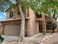 Charming two-story home with a well-maintained front yard and attached two-car garage at 8732 W Adam Ave, Peoria, AZ 85382