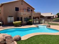Backyard view featuring a large, private pool and patio area, perfect for outdoor entertaining at 8732 W Adam Ave, Peoria, AZ 85382