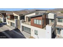 Modern two-story home with a sleek design, garage and balcony, showcasing contemporary architectural details at 1 Easy St # 5, Carefree, AZ 85377