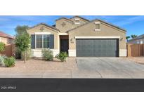 Charming single-story home with a two-car garage and low-maintenance landscaping at 1127 E Tyler Ln, Casa Grande, AZ 85122