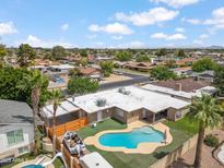 Aerial view of backyard pool with a slide, boat, and outdoor entertaining area at 1308 S Spur --, Mesa, AZ 85204