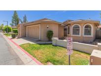 Charming single-story home with a well-manicured lawn and two-car garage at 18002 N 12Th St # 45, Phoenix, AZ 85022
