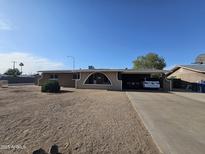 Single-story home with desert landscaping and an arched accent over the front window at 1904 E Jarvis Ave, Mesa, AZ 85204