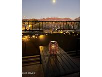 Peaceful balcony illuminated by string lights under the night sky, serene mountain backdrop at 19550 N Grayhawk Dr # 2023, Scottsdale, AZ 85255