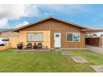 Charming single-story home with a well-maintained lawn and inviting front patio seating at 2132 W Chambers St, Phoenix, AZ 85041