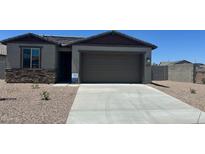 Charming single-story home featuring a stone facade, neutral stucco, and a spacious two-car garage in a desirable community at 25138 W Wayland Dr, Buckeye, AZ 85326