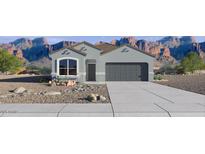Charming single-Gathering home with a two-car garage and desert landscaping against mountain views at 25455 N 183Rd Dr, Wittmann, AZ 85361