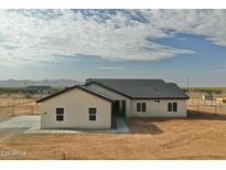 Lovely single-story home showcasing the desert landscape with a neutral palette and stylish architectural design at 25876 W White Feather Ln, Wittmann, AZ 85361